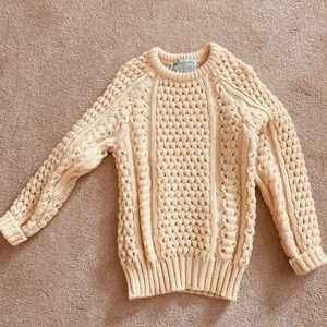 Cream colored cable knit small sweater.